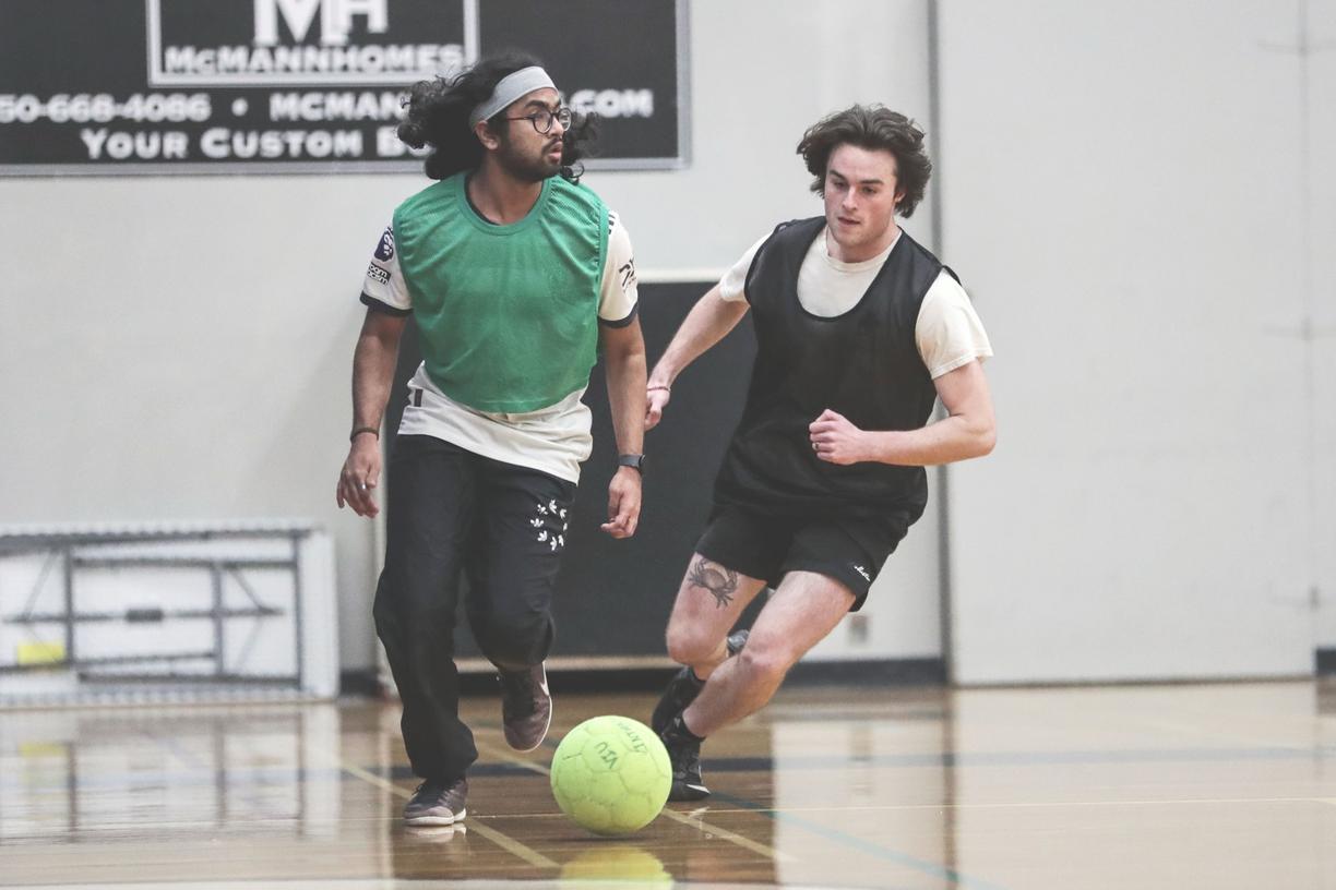 Two soccer players battle for possession of the soccer ball