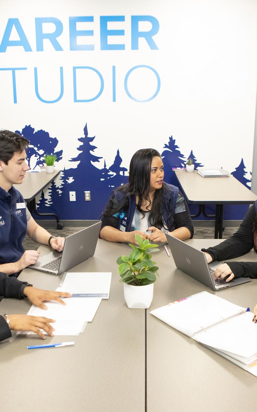 Male and female Career Studio staff working together at a table
